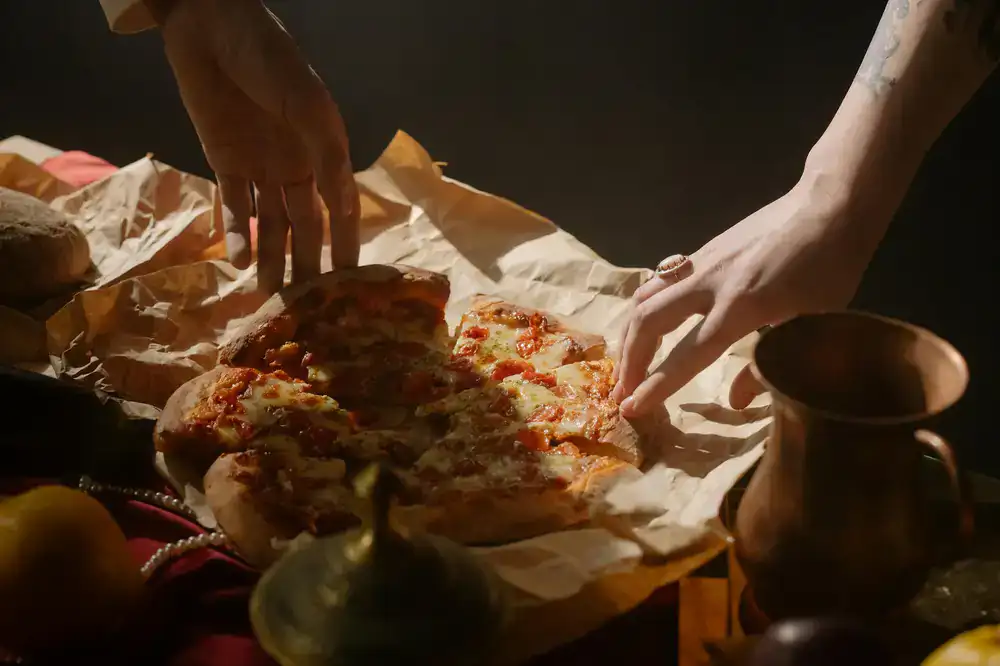 Close up of a freshly baked rustic pizza being sliced